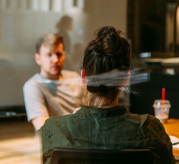 person sitting in a chair in front of a man